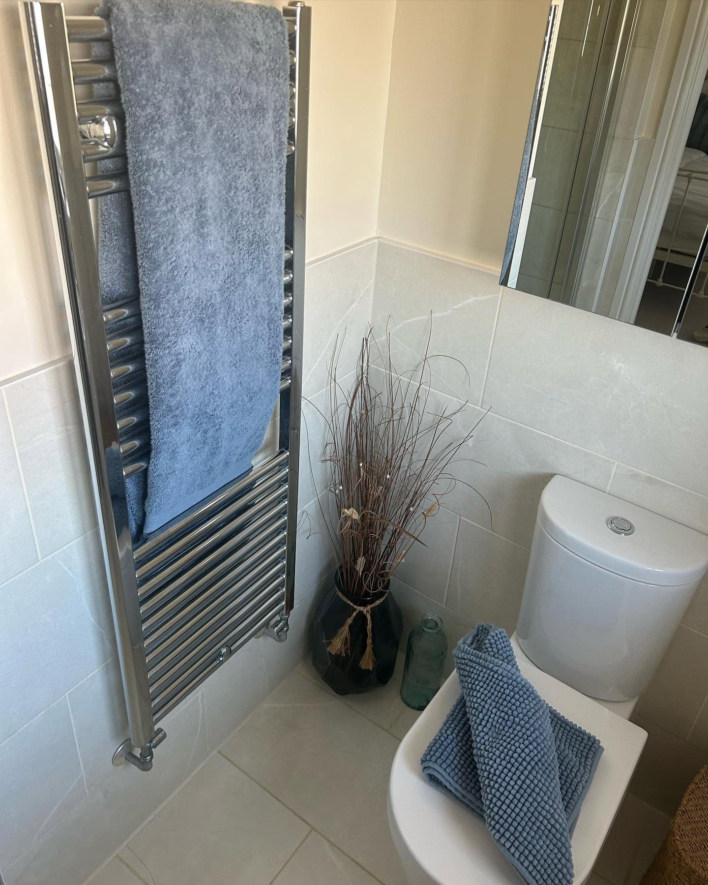 Clean bathroom corner with towel rail