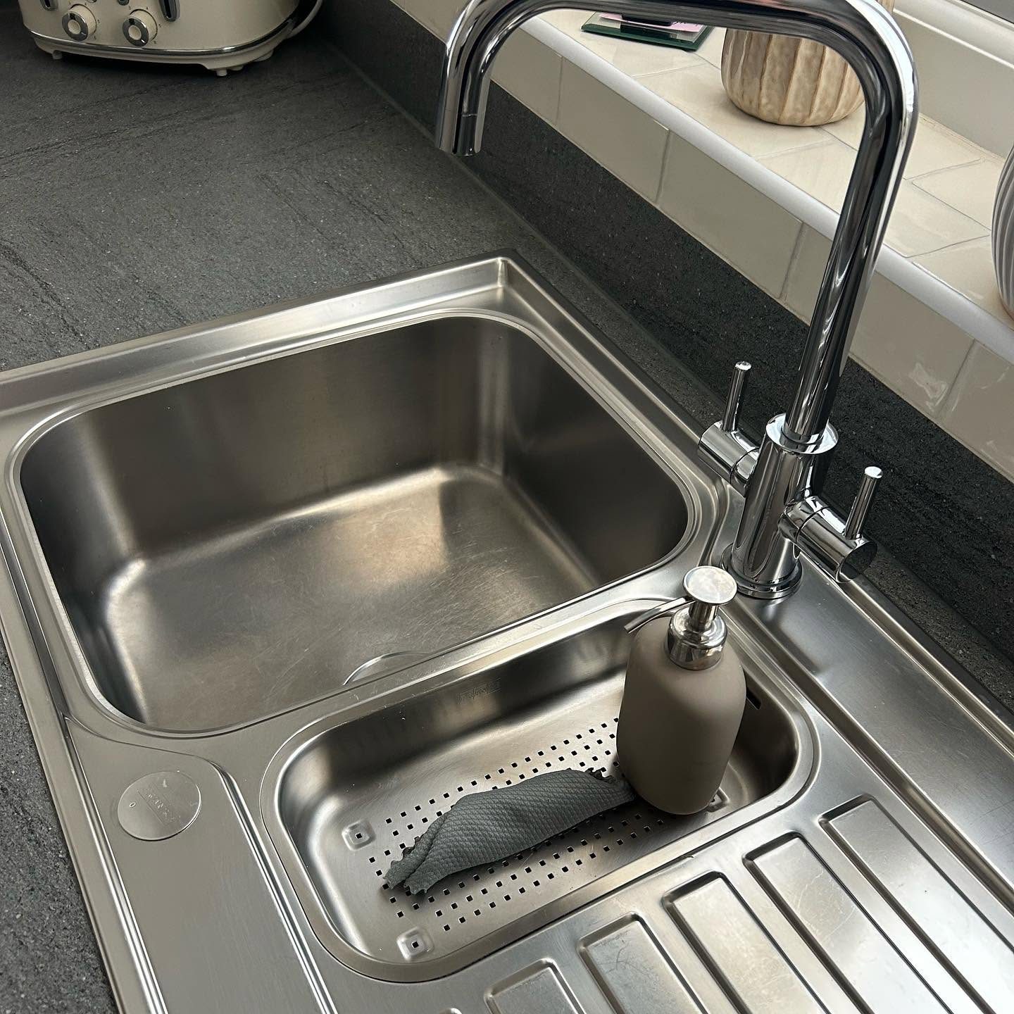 Chrome tap on dark worktop